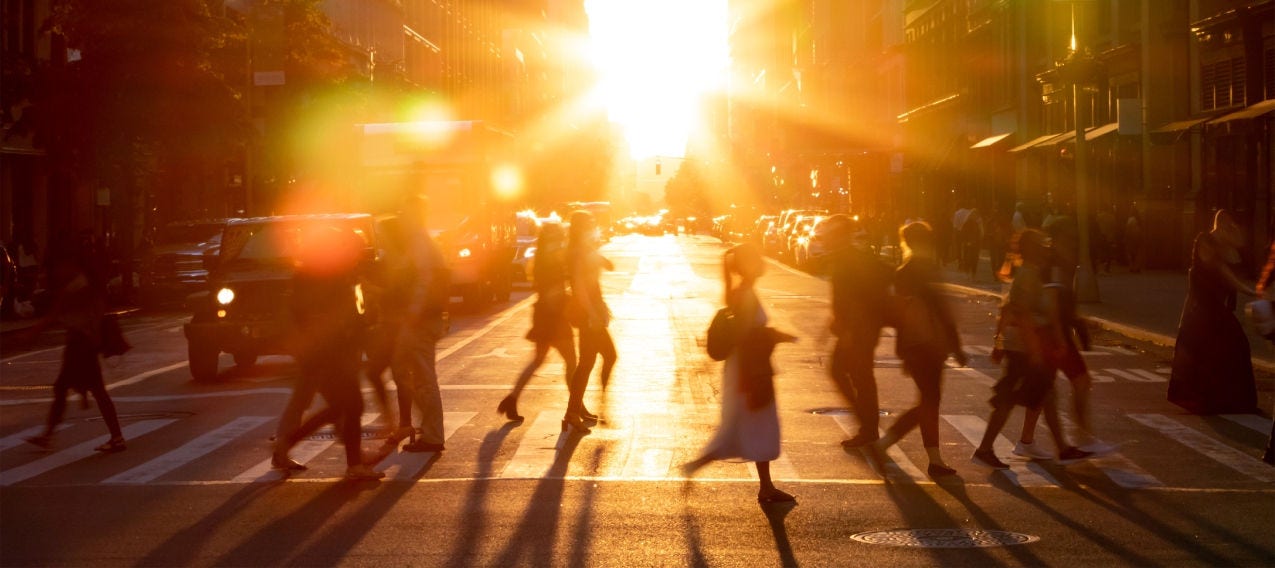 Pedestrians crossing a city street, reflecting the interconnected systems that support everyday urban life