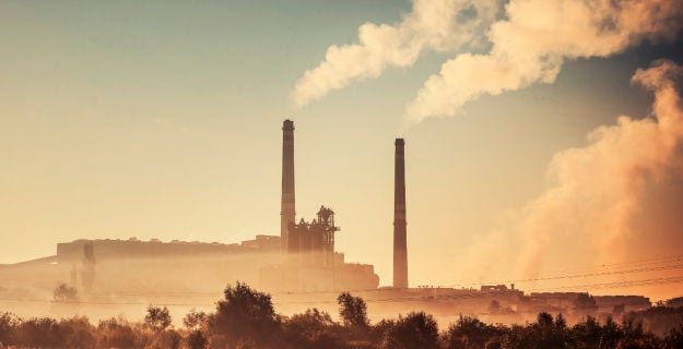 Power generation facility with cooling towers, illustrating the complexity of interconnected systems in critical infrastructure.