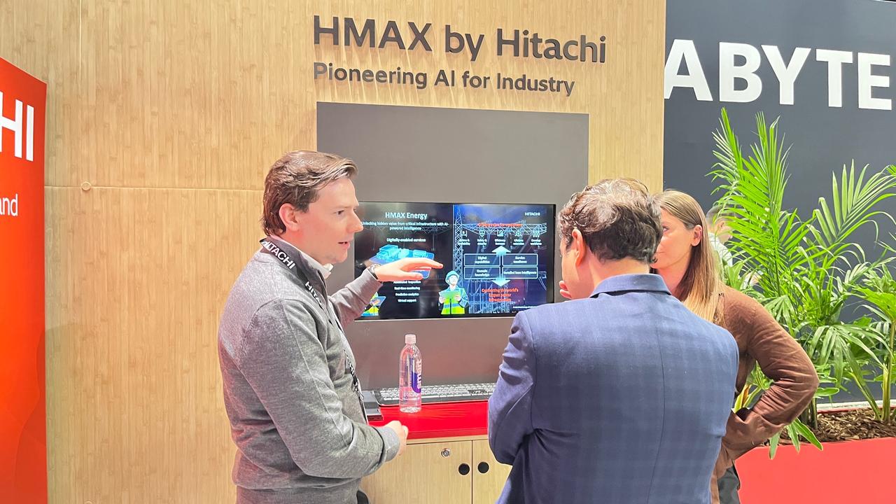 画像: (インフラの安定稼働を支える「HMAX Energy」展示説明の様子）