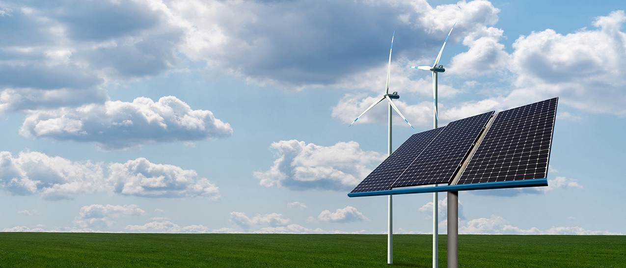 Solar panels and wind turbines on a green field. Sustainable energy concept