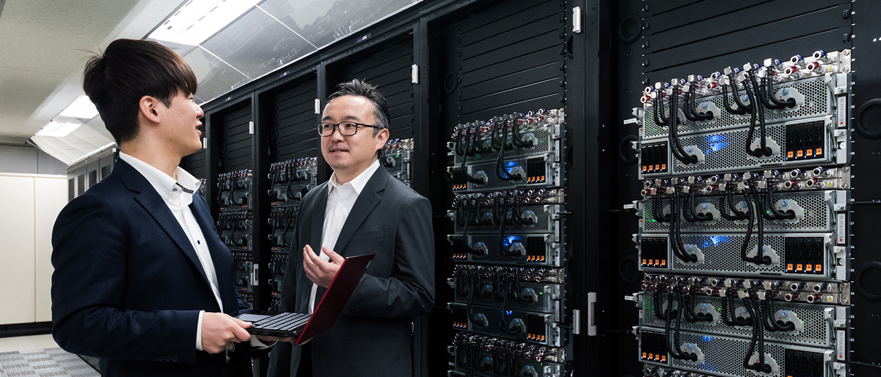 Two Hitachi workers in a data center