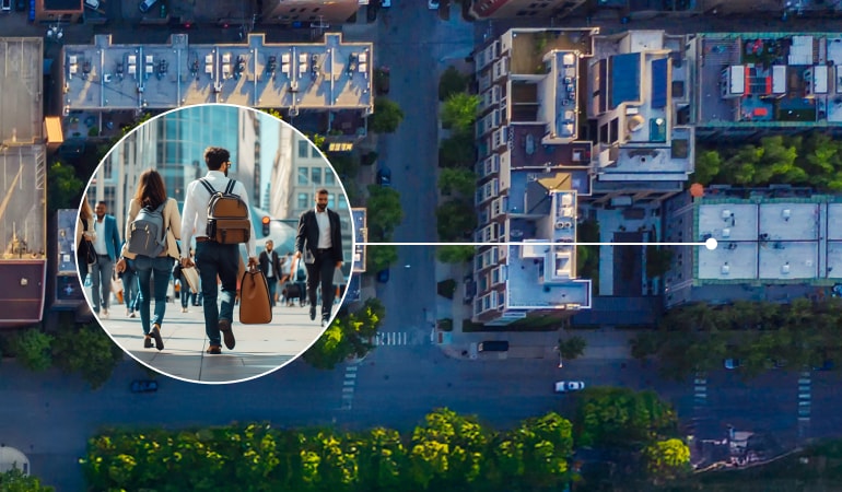 Aerial view of a city. Inset circle zooms in showing a group of people walking on a street
